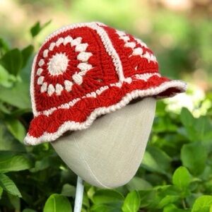 Handmade crochet bucket hat with a retro red and white sunburst pattern